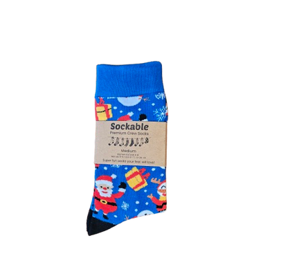 Packaged pair of socks with Santa Claus design on a white background